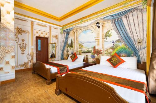 two beds in a room with a painting on the wall at Collection O Bao Duy Hotel in Ho Chi Minh City