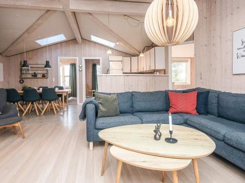 a living room with a blue couch and a table at 8 person holiday home in Børkop in Børkop