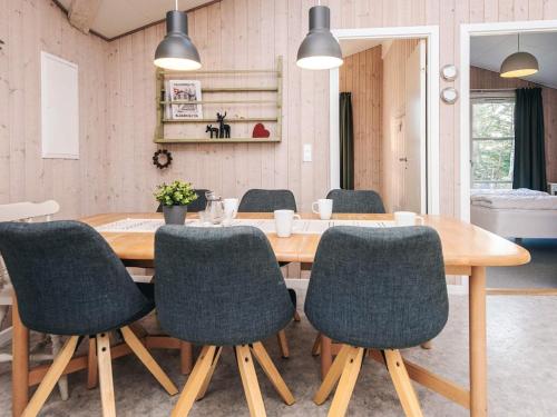 a dining room with a wooden table and chairs at 8 person holiday home in Børkop in Børkop