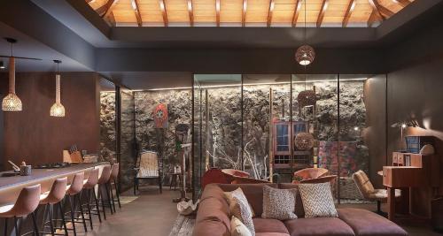a lobby with a couch and a bar with chairs at Smart Elegant Villa with Amazing Tropical Views in Toiny