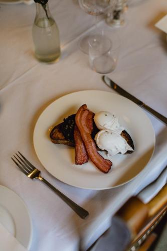 a plate of breakfast food with eggs bacon and toast at The White Hart in Wiveliscombe