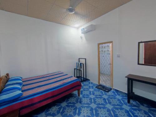 a bedroom with a bed and a table in it at Vino lanka in Trincomalee