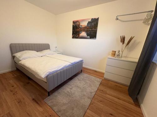 a bedroom with a bed and a painting on the wall at Klytti‘s Pension in Sendenhorst