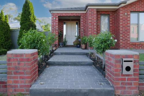 a red brick house with a brick walkway at Gem Home in Peppercorn Estate in North Bendigo Junction