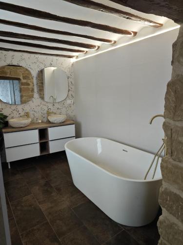 a bathroom with a large white tub and a mirror at Arturana turismo in Ollauri