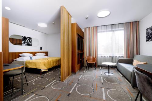 a hotel room with a bed and a couch at Hestia Hotel Kentmanni in Tallinn