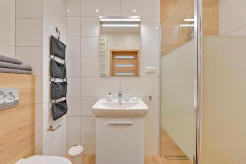 a bathroom with a toilet and a sink and a shower at Flatbook - Seaside Apartments Tre Mare II in Gdańsk