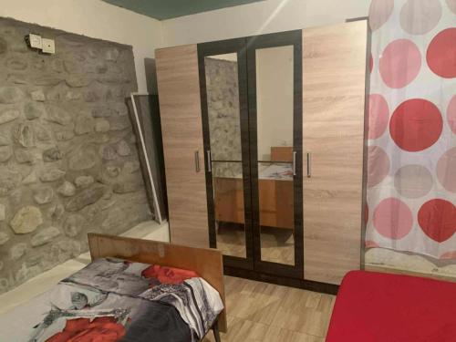 a bedroom with a bed and a large mirror at Village house in Telavi