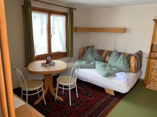 a living room with a couch and a table at Cottage Grundschera Engadin in Brail