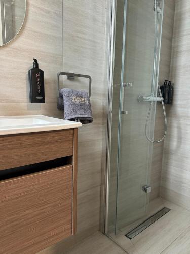 a bathroom with a shower and a sink at Nesea Seaside Luxury Escape in Protaras