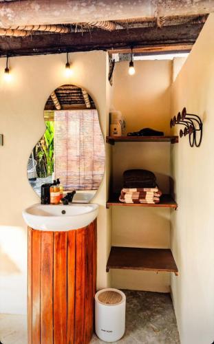 a bathroom with a sink and a mirror at Garden House Balangan in Uluwatu