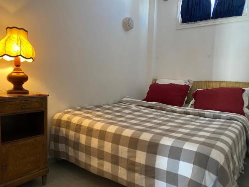 a bedroom with a bed and a lamp on a table at Birdhouse Sidi Bou Said in Dar Mimoun Bey