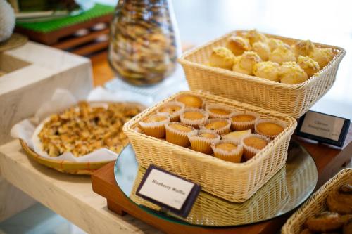 two baskets of pastries and a pizza on a table at Solea Mactan Resort in Mactan