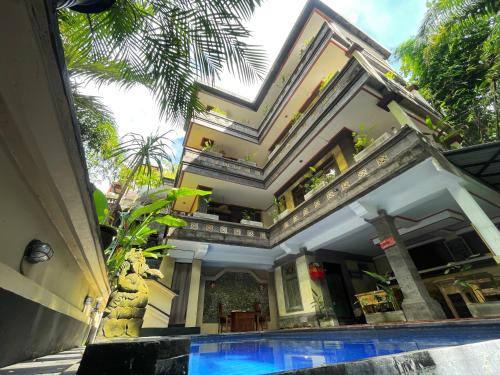 a house with a swimming pool in front of a building at The Nest in Ubud in Ubud