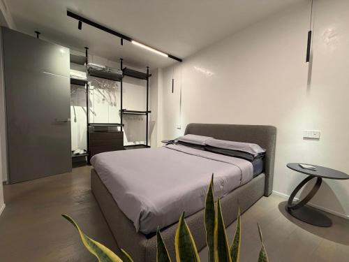 a bedroom with a bed and a table and a plant at Nuovo Fiore in Pesaro
