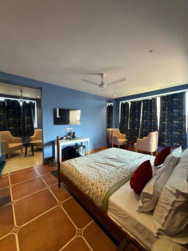 a bedroom with a large bed with a blue wall at The Solo House in Jodhpur