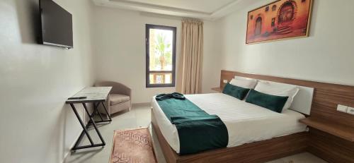 a bedroom with a bed and a television in it at Hotel Anna Agadir in Agadir