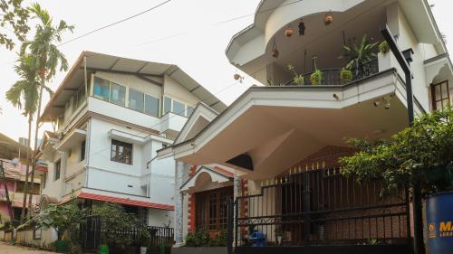 a building with a balcony on the side of it at Spacious 3-Bedroom Private Villa in Mangalore - Ideal Getaway for Family and Friends in Mangalore