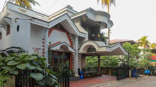 a house with a staircase on the side of it at Spacious 3-Bedroom Private Villa in Mangalore - Ideal Getaway for Family and Friends in Mangalore