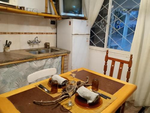 a small kitchen with a wooden table and a sink at Aldea Grampas in Embalse