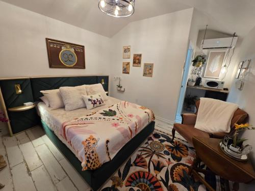 a bedroom with a bed and a chair at Roots Retreat in Seymour