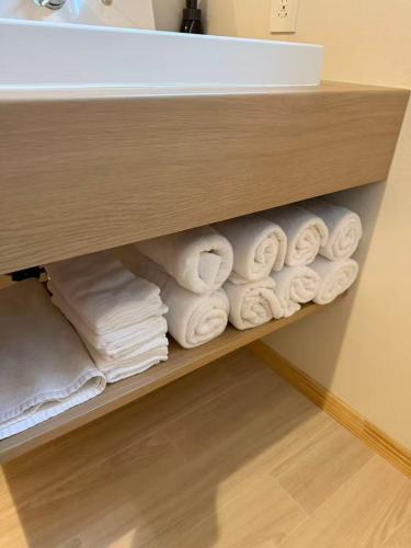 a bunch of towels on a shelf in a bathroom at 小宿 和Nagomi in Kobe