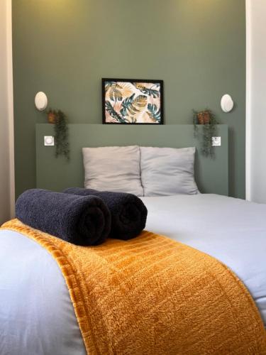 a bedroom with a bed with towels on it at L'arquebuse - Gare Dijon in Dijon