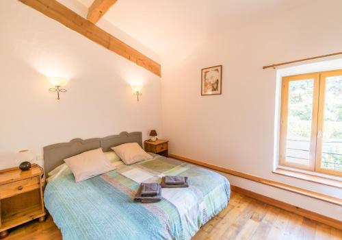 a bedroom with a bed and a window at Eloi Merle Gîtes in Olonzac