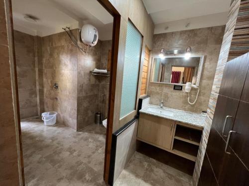 a bathroom with a shower and a sink and a mirror at MJ Funcity Water Park & Resort in Lucknow