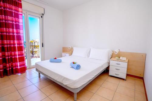 a bedroom with a bed and a large window at Residence Playa Sirena in Tortoreto Lido