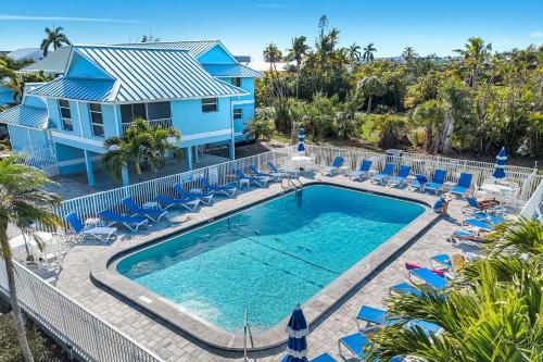 an aerial view of a pool with chairs and a house at Seashells #45 in Sanibel
