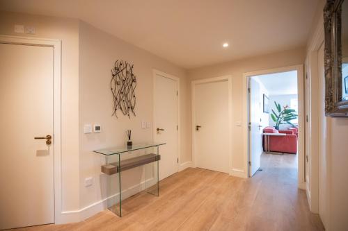 a hallway with a glass table in a room at Parnell Corner Apartments in Dublin