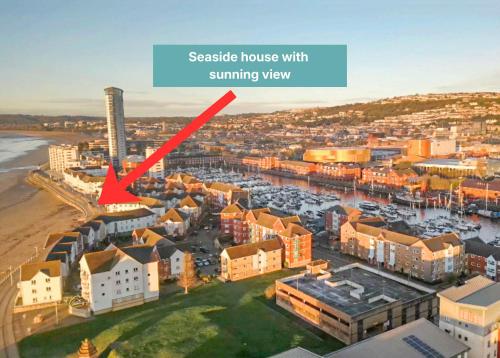 ayscape of a city with a red arrow labelingcastle house with summer view at Stunning Swansea Marina beach house with sea views in Swansea