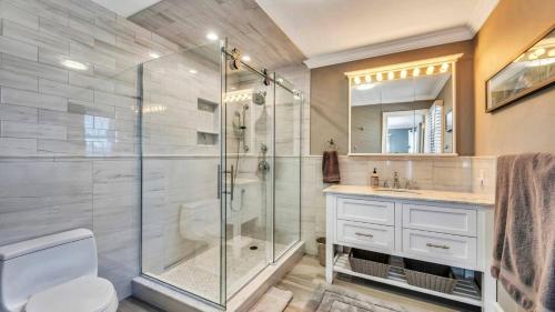 a bathroom with a shower and a toilet and a sink at Villa Saltwater Haven in East Hampton