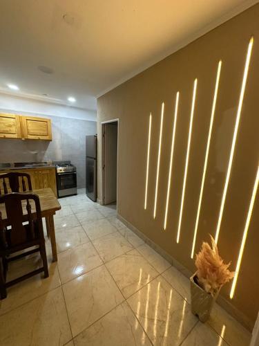 a kitchen with a wall with vertical blinds on it at Departamento Helen in Termas de Río Hondo