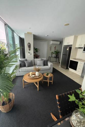 a living room with a couch and a table at Brighton Shores 1 bedroom apartment in Gold Coast