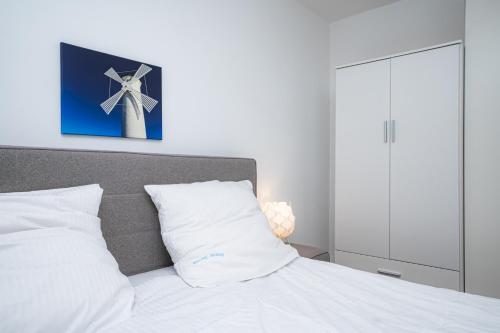 a bedroom with a bed with a picture of a windmill at Liehrstraße 9 by Baltic Home in Heringsdorf