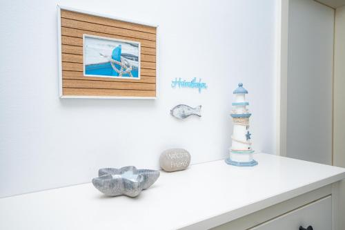 a white counter in a bathroom with a picture on the wall at Liehrstraße 9 by Baltic Home in Heringsdorf