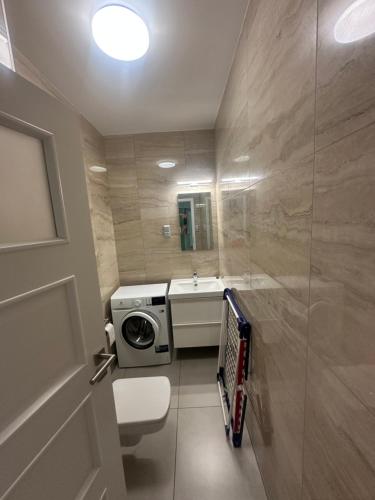 a bathroom with a toilet and a sink at Fűzliget2- Green Lake in Balatonfůzfő