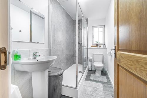 a white bathroom with a sink and a toilet at Super Prime Train Station Inverkeithing by TBA in Inverkeithing