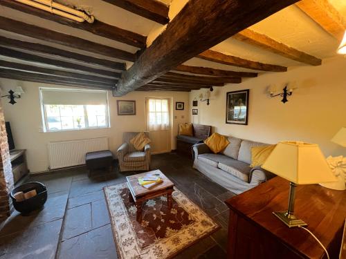 a living room with a couch and a table at White Horse Cottage with Sauna in Ollerton