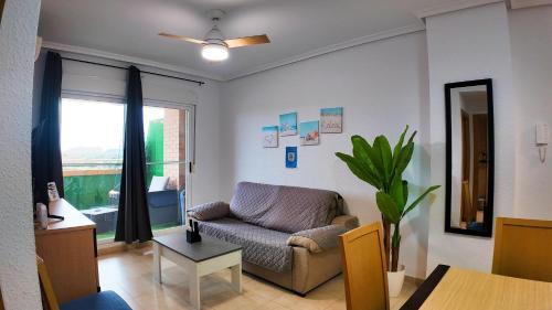 a living room with a couch and a window at Apartalux Magic Silver in Oropesa del Mar