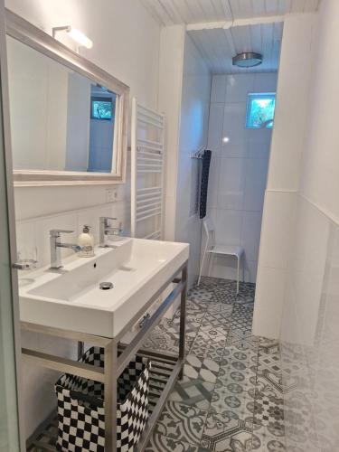 a white bathroom with a sink and a shower at BlauweBoshuis in Koekange