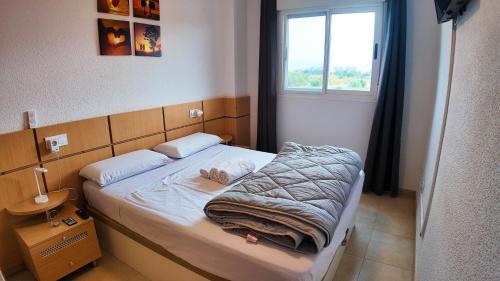 a small bed in a room with a window at Apartalux Magic Silver in Oropesa del Mar