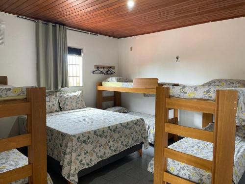 a room with two bunk beds and a bed at Hostel mineiros in Aracaju