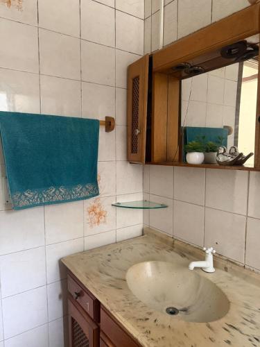 a bathroom with a sink and a mirror at Casa de temporada in Camboriú
