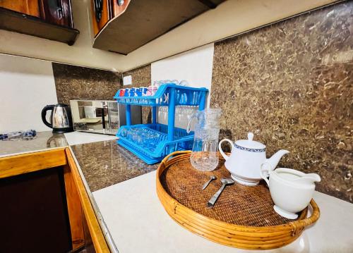 a kitchen counter with a wooden tray with a tea set at White Hill Villa in Nuwara Eliya