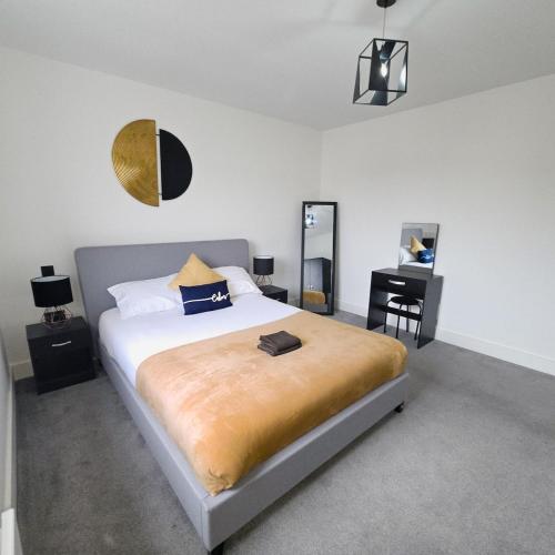 a bedroom with a large bed and a mirror at Modern - City Centre - Free parking in Norwich