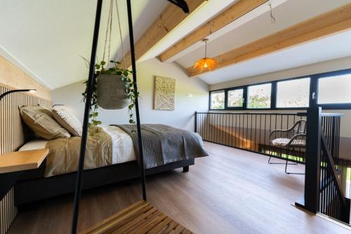 a bedroom with a bed and a balcony at Schoapdiek Huuskes in Overdinkel