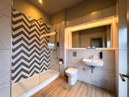 a bathroom with a shower toilet and a sink at Royal Whitby in Whitby